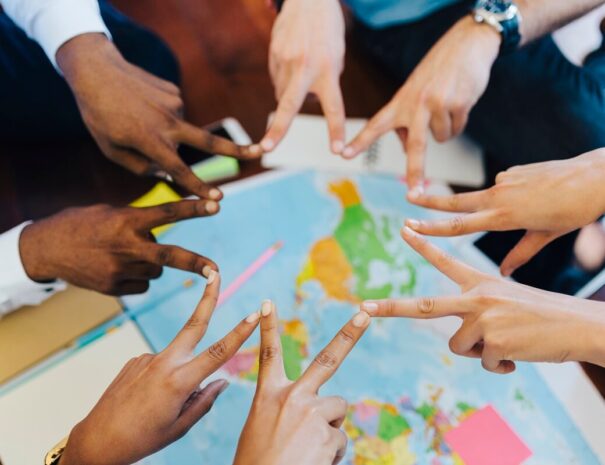 group-of-friends-making-hand-sign-above-world-map-2024-09-17-07-48-36-utc (1)